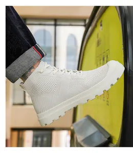 Side view of white high-top knitted sneakers with breathable mesh and thick rubber soles