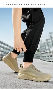 Close-up of olive green wide-toe breathable mesh sneakers for men on a city street