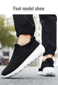 Outdoor model show of black knitted slip-on casual sneakers with white sole for couples