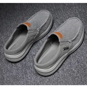 Detail of grey canvas mule loafers with leather trim and thick anti-slip rubber sole