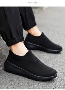 Close-up of black breathable mesh walking shoes on asphalt ground for men