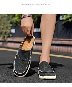 Close-up of grey canvas slip-on shoe featuring white stitching and cork texture insole