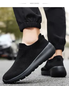 Close-up of black breathable mesh slip-on sneakers with cushioned soles on model feet