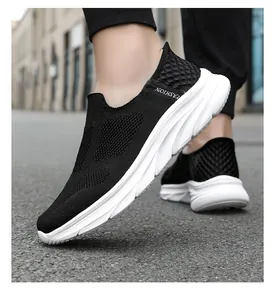 Close-up of black breathable knit mesh upper and thick white sole on men's walking shoes