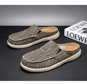 Detail of taupe canvas mule shoes with raw edges and comfortable cork texture insoles
