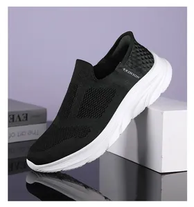 Detail view of breathable knitted mesh fabric and thick shock-absorbing sole on walking shoes