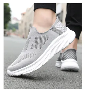 Close-up of breathable grey mesh fabric and thick cushioned white sole on walking shoes