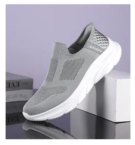 Macro detail of breathable grey fly-knit mesh and FASHION ribbon on men's walking shoes