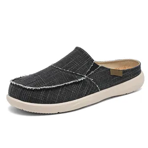 Men's dark grey canvas backless slip-on sneakers with frayed edges and thick cream sole