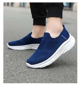 On-foot view of breathable navy mesh slip-on shoes with cushioned white soles