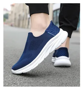 Detail of navy blue slip-on mesh sneakers with white FASHION logo and cushioned sole