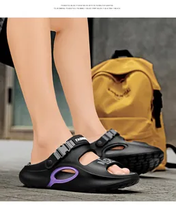 Detail of black EVA beach sandal with purple accents and sport fashion lettering