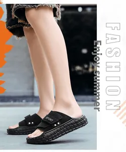Detail view of black men's sport slides with metal rivets and anti-slip thick soles
