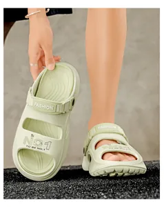 Detail of mint green EVA beach sandals featuring breathable cut-outs and fashion prints