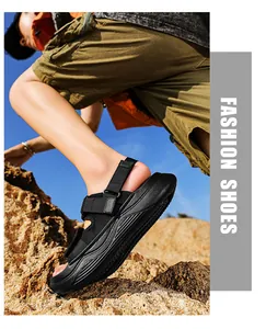 Outdoor shot of men's black fashion sandals with thick athletic soles on rocky terrain