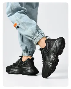 On-foot side view of black chunky sneakers with mesh upper and thick cushioned soles