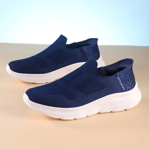 Navy blue breathable fly-knit slip-on walking shoes with a thick white cushioned sole