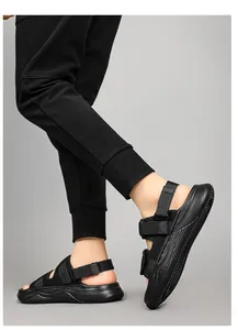 Detailed side view of black outdoor sports sandals with fabric straps and thick rubber soles