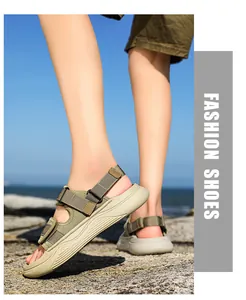 Detailed side view of khaki outdoor sports sandals with thick non-slip soles on rocks