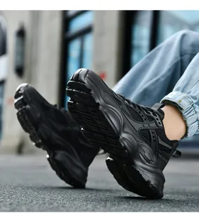 Close-up of the thick anti-slip rubber sole and textured mesh upper of the black dad shoes