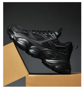 Close-up of black chunky sneakers with breathable mesh texture and thick shockproof soles