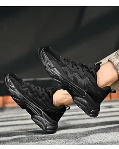 Detail of all-black chunky sneakers showing multi-material mesh and wave texture side