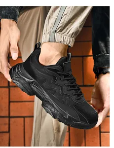 Macro shot of black men's dad sneakers featuring mesh fabric and thick cushioned sole
