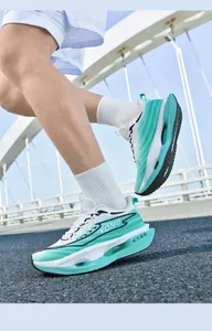 Detail of running shoes with hollow cushioning sole and breathable mesh in white and green