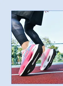 Low angle shot of pink and white running shoes featuring a hollow cushioning midsole design