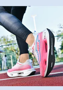 Macro shot of breathable mesh upper and hollow shock-absorbing midsole on pink running shoes