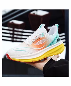 Detail of white running shoe with orange-green gradient mesh and yellow midsole