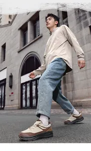 Men's casual leather sneakers styled with denim jeans for a trendy outdoor city look
