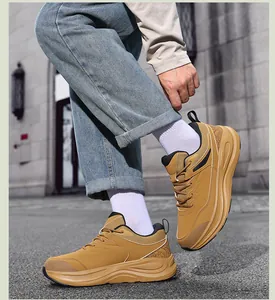 Close-up of tan chunky sneakers with mixed materials and cushioned soles for men