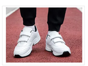 Detail shot of white velcro walking shoes with breathable synthetic leather and thick soles
