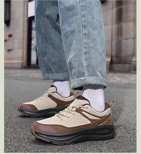 Close-up of beige and brown leather patchwork sneakers with durable rubber outsoles