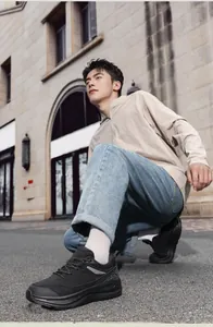 Close-up of black cushioned casual men's sneakers with anti-slip soles in a street style view