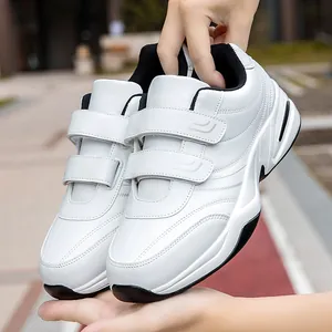 Men's white walking sneakers with dual velcro straps and durable black rubber soles