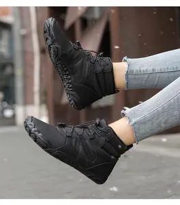 Detail of waterproof black winter outdoor tactical boots with anti-slip rubber sole