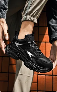 Detail of chunky men's sneakers featuring a thick shock-absorbing sole and wave patterns