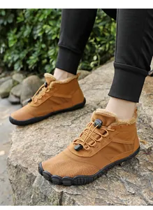 Outdoor shot of brown barefoot winter boots with plush lining and drawstring laces
