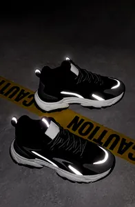 Detail view of black retro dad shoes featuring high-visibility luminous reflective strips