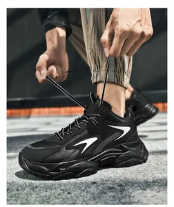 Close-up of black chunky sneakers for men with thick shock-absorbing soles and white accents