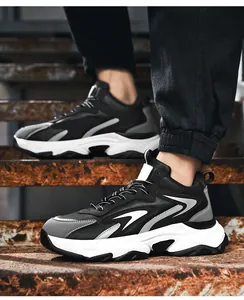 Close-up of men's chunky sneakers featuring thick shock-absorbing soles on industrial stairs