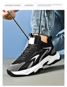 Detail of man tying laces on chunky mesh sneakers with thick shock-absorbing soles