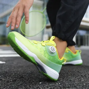 Neon green professional badminton shoes with a rotating knob lacing system and breathable mesh