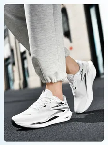 Close-up of white running shoes with thick cushioning and side stripe details