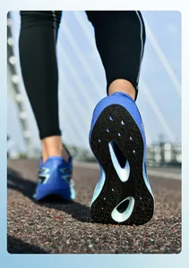 Macro shot of the durable blue rubber outsole with anti-slip texture on a running shoe