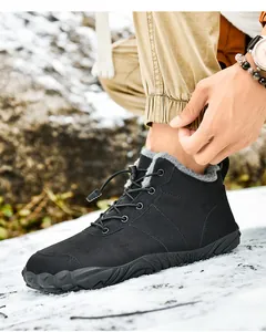 Close-up of black winter boots with warm gray fleece lining and durable non-slip rubber soles