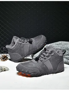 Detail of dark grey winter boots featuring plush lining and rugged anti-slip rubber soles
