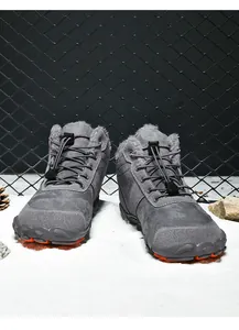 Detail of warm grey high-top outdoor boots with faux fur lining and bungee laces